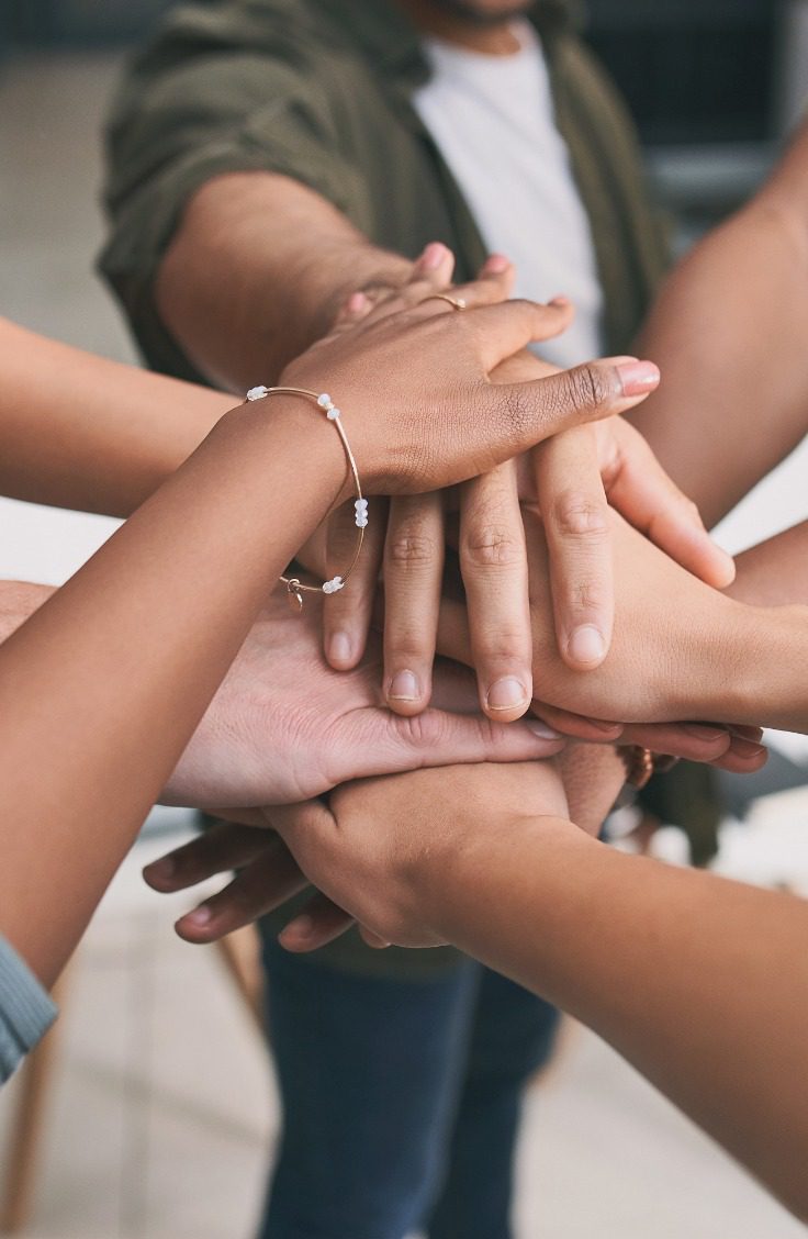 Hard work beats talent if talent doesnt work hard. a unrecognizable team of business people stacking their hands in motivation.<br />
